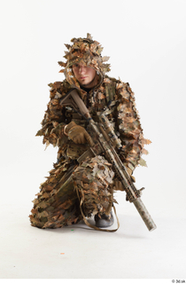 Frankie Perry in Ghillie kneeling with Gun holding gun kneeling…